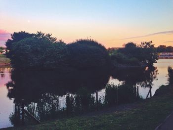 Scenic view of lake at sunset