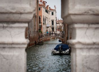 Bridge over canal amidst buildings in city