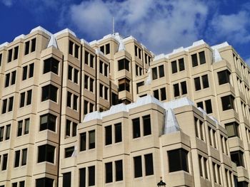 Low angle view of building against cloudy sky