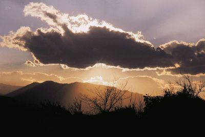 Scenic view of silhouette mountains against sky at sunset