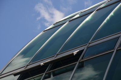 Low angle view of office building against blue sky