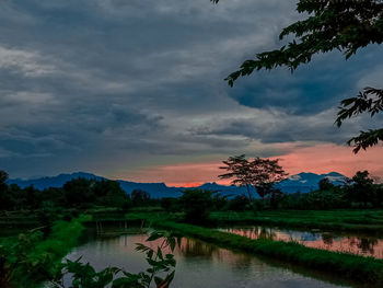 Scenic view of lake against sky during sunset