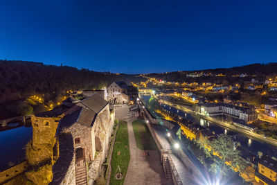 High angle view of city lit up at night