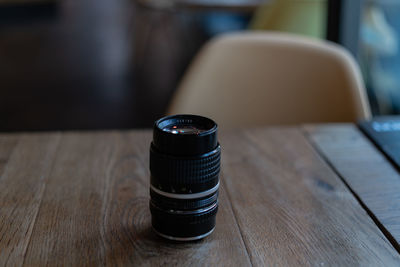 Close-up of lens on wooden table