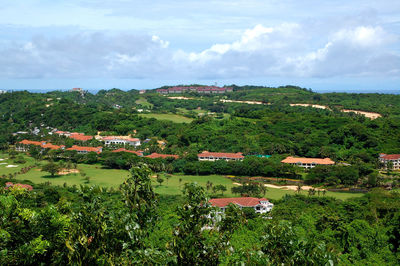 High angle view of trees and buildings against sky