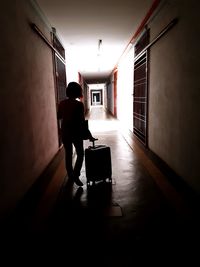 Silhouette man walking in corridor