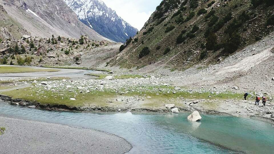 water, mountain, scenics, beauty in nature, tranquility, mountain range, tranquil scene, nature, lake, river, non-urban scene, rock - object, waterfront, day, idyllic, winter, incidental people, outdoors, snow