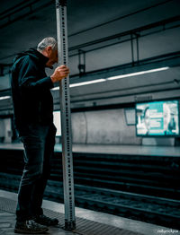 Man standing on railroad station platform