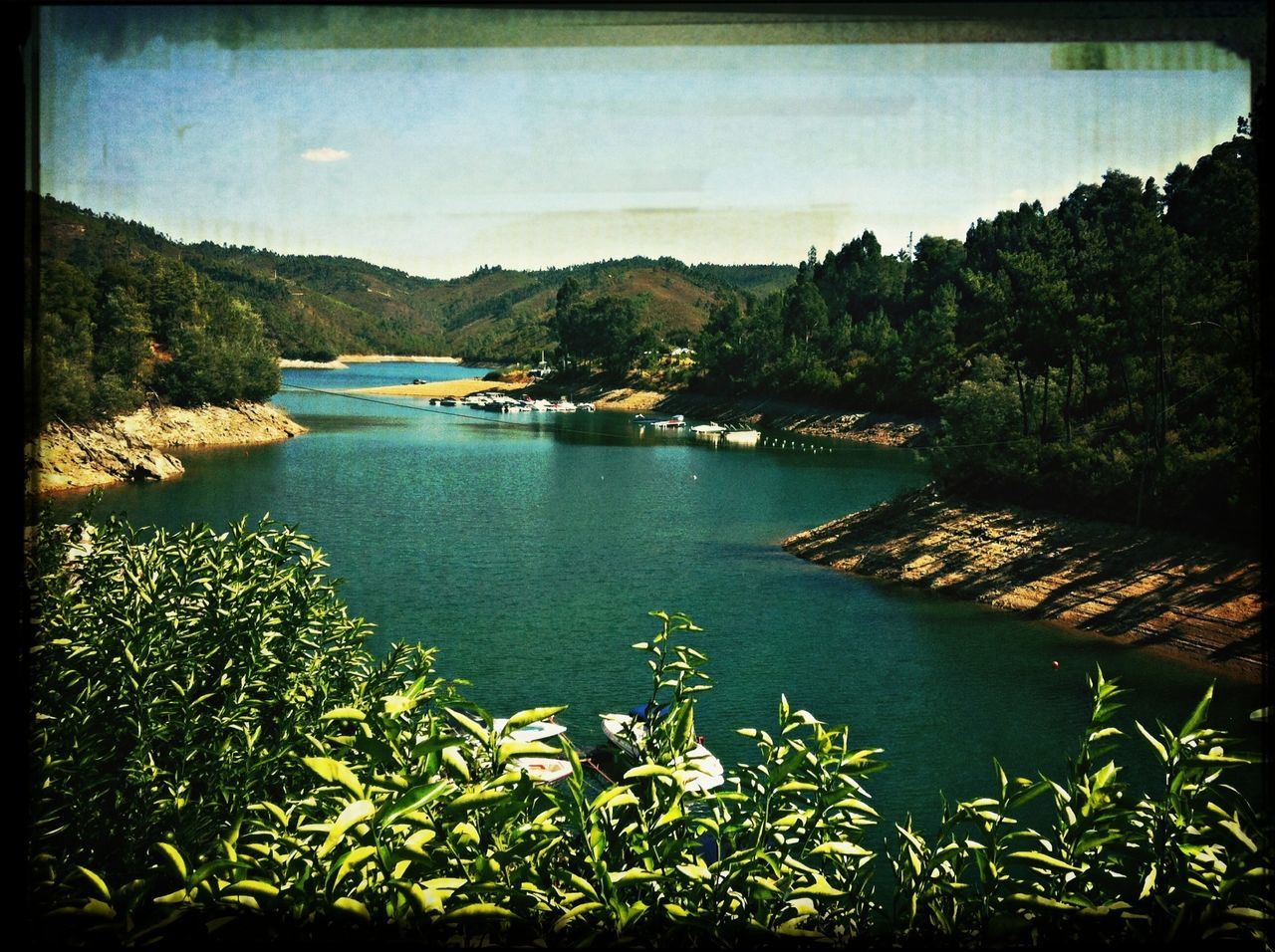 water, tranquil scene, tranquility, scenics, transfer print, sky, lake, beauty in nature, mountain, nature, tree, auto post production filter, sea, idyllic, plant, calm, river, mountain range, lakeshore, outdoors