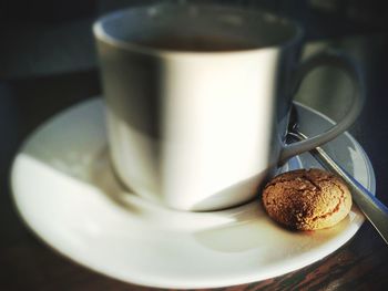 Close-up of coffee and cookie on table