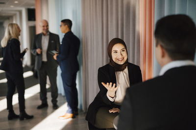 Coworkers talking in office