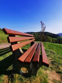 Built structure on field against clear blue sky