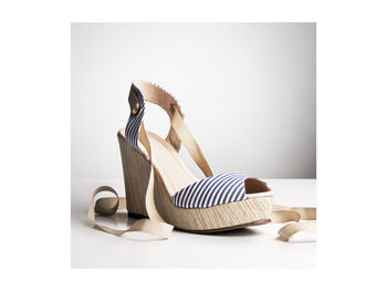 Close-up of shoes on table against white background