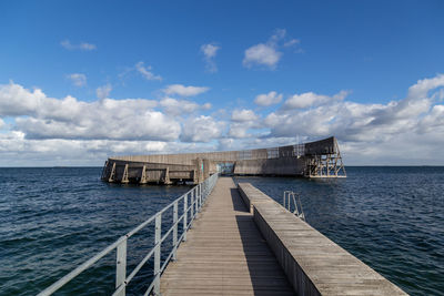 Pier over sea against sky