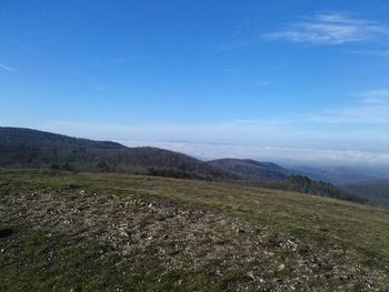 Scenic view of landscape against blue sky