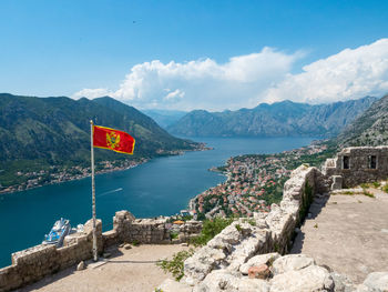 Scenic view of sea and mountains against sky