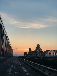 View of bridge against cloudy sky during sunset