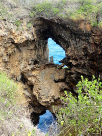 Rock formation in sea seen through cave