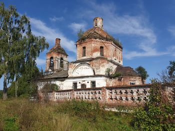 Abandoned place low angle view of traditional building against sky