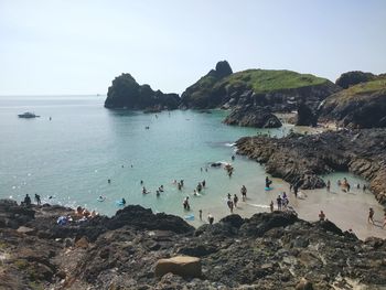 People on beach against sky