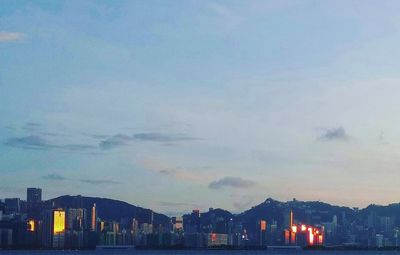 View of cityscape against cloudy sky