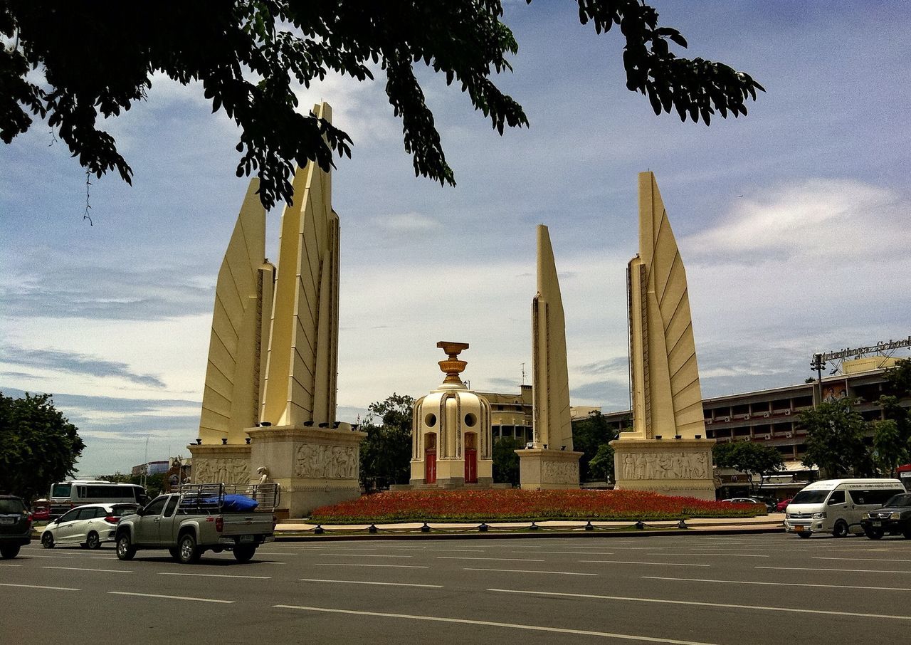 transportation, tree, car, mode of transport, road, monument, land vehicle, architecture, tall - high, built structure, tower, architectural column, travel destinations, history, outdoors, the past, tall, sky, memories, day, tourism, famous place