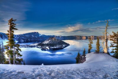 Scenic view of frozen lake against sky during winter