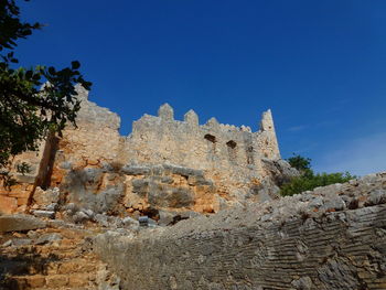 Low angle view of fort against blue sky