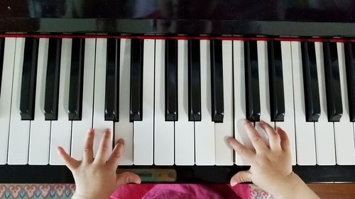 Low section of person playing piano