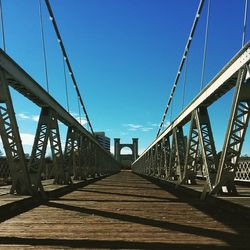 Suspension bridge against blue sky