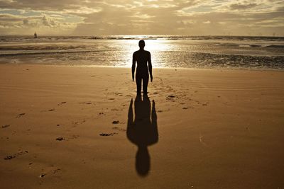 Rear view of man standing on beach