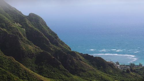 Scenic view of sea and mountains against sky