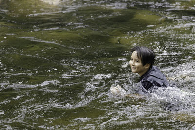 Portrait of smiling woman in water