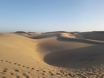 Scenic view of desert against clear sky