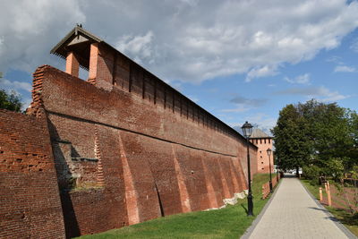 Exterior of building by road against sky