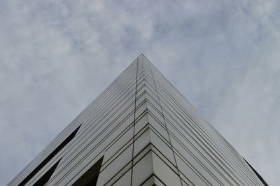 Low angle view of modern building against cloudy sky