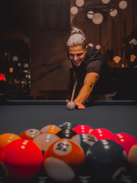 Portrait of woman playing pool