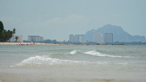 Scenic view of sea and buildings against sky