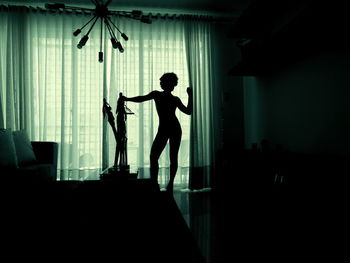 Silhouette woman standing at home