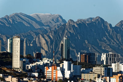 Built structures against rocky mountain range