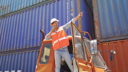 Low angle view of person standing on metallic structure