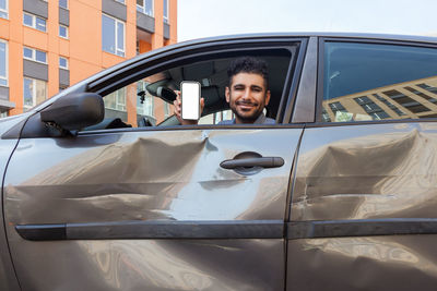 Portrait of smiling man in car