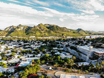 High angle view of townscape by road against sky