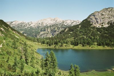 Scenic view of lake and mountains against clear sky