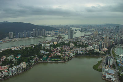 High angle view of river amidst buildings against sky