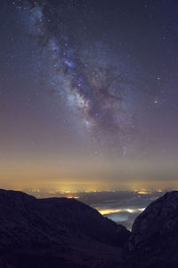 Scenic view of mountains against sky at night