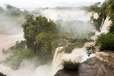 Scenic view of waterfall against sky