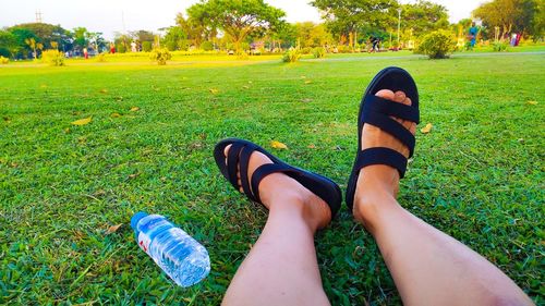 Low section of woman relaxing in park