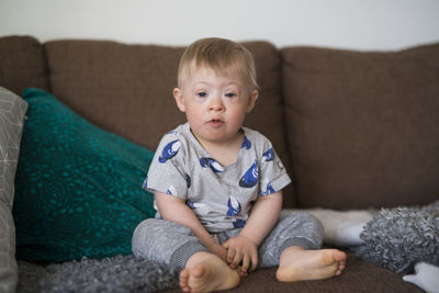 Boy looking at camera barefoot