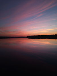 Scenic view of lake against romantic sky at sunset